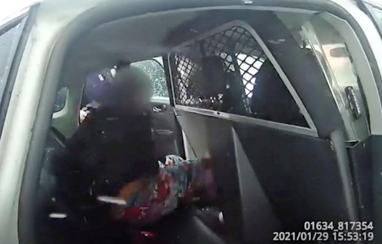 A still frame from a police body-camera video shows a nine-year-old girl handcuffed in a police cruiser in Rochester, New York, Jan 29. Photo: AP