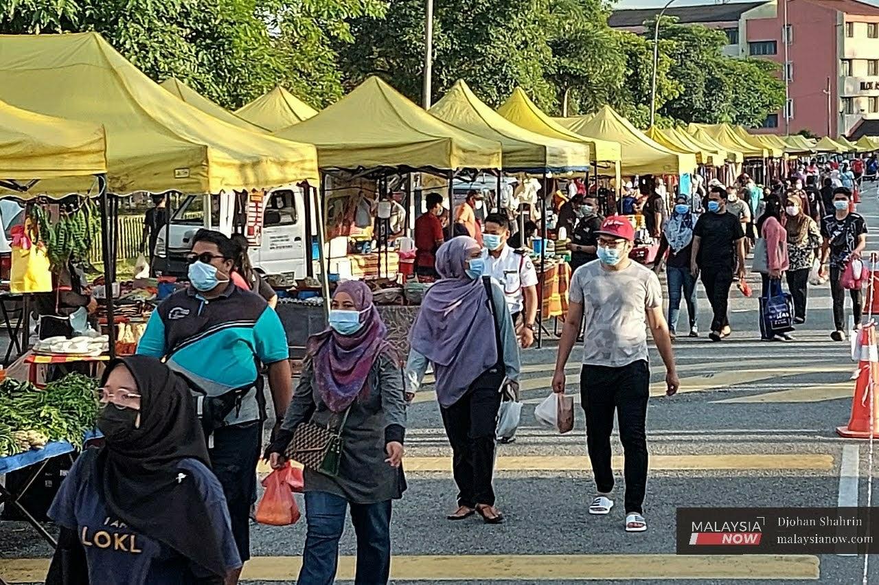 Pengunjung mencari barang keperluan di pasar malam Taman Keramat AU2, selepas kerajaan melonggarkan syarat operasi perniagaan.