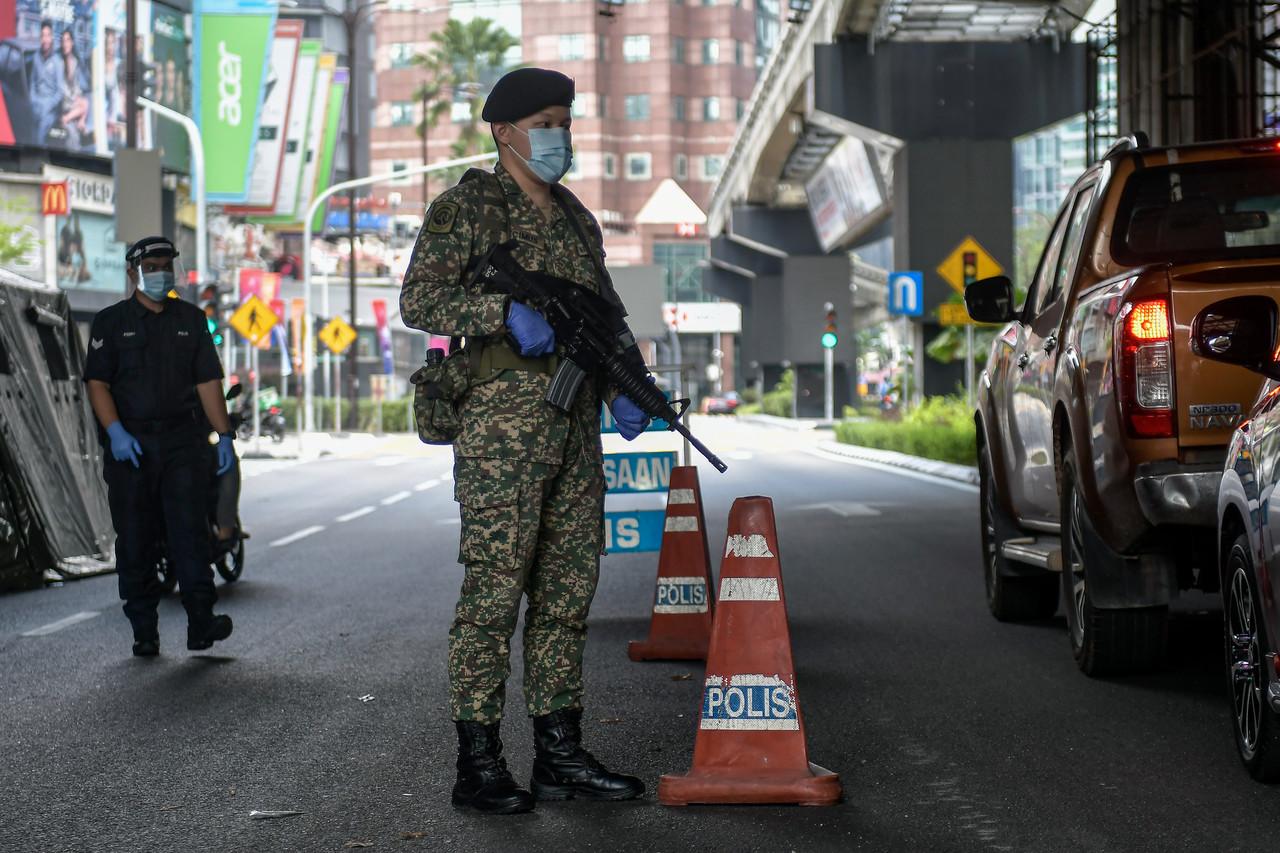 A member of the armed forces stands guard at a roadblock in downtown Kuala Lumpur. The armed forces will be given the power to arrest those found to have breached Covid-19 SOPs. Photo: Bernama