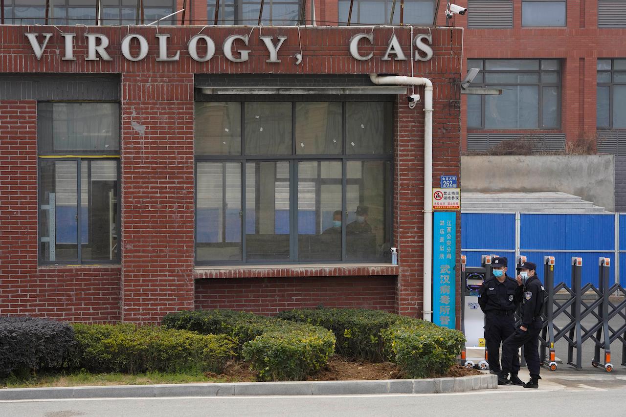 Security personnel gather near the entrance of the Wuhan Institute of Virology during a visit by the World Health Organization team in Wuhan, China, Feb 3. Photo: AP