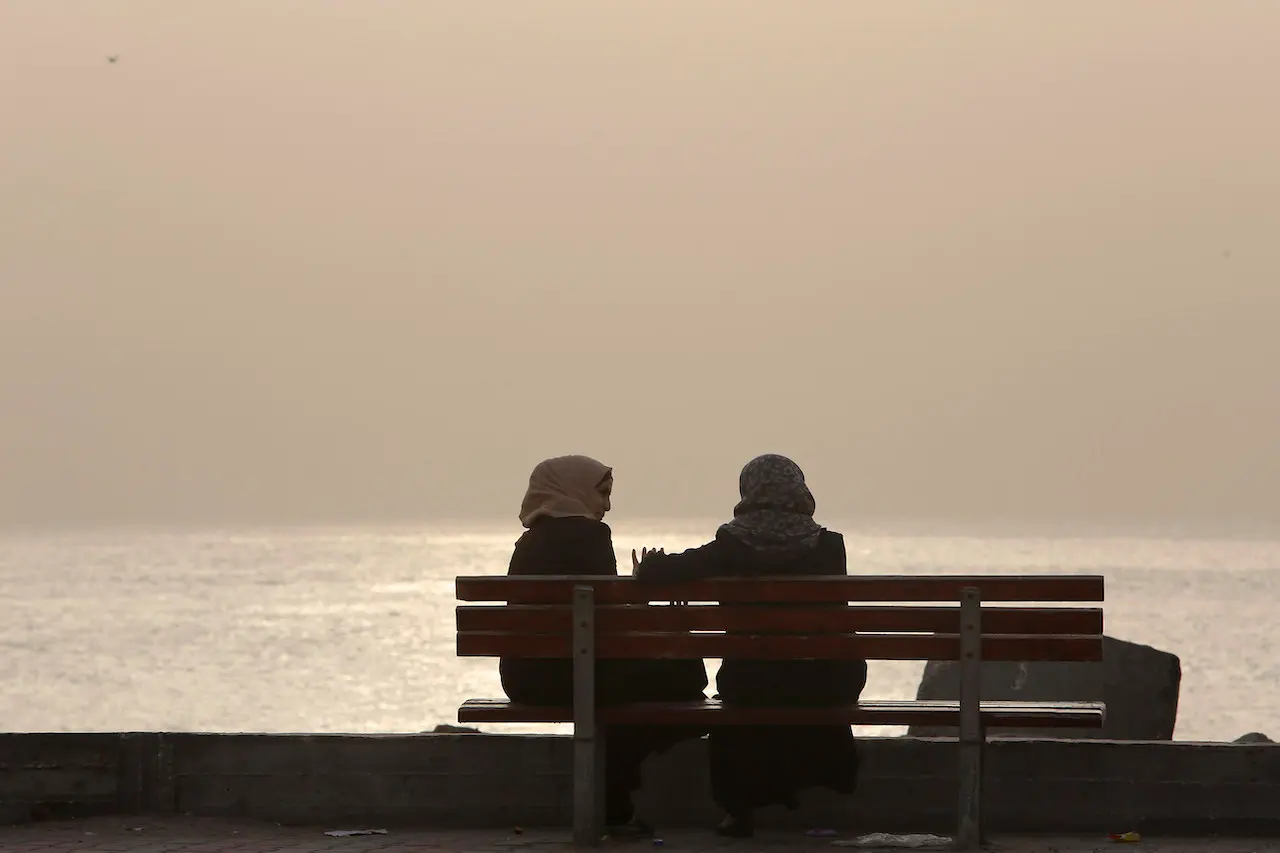Palestinian women sit by the Mediterranean Sea at sunset during a sandstorm in Gaza City. Lebanon, Tunisia and the Palestinian Authority have abolished laws that treat honour crimes leniently. Photo: AP