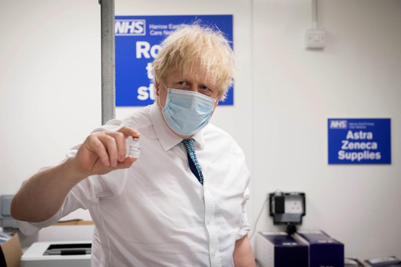 Britain's Prime Minister Boris Johnson holds a vial of the Oxford AstraZeneca Covid-19 vaccine on Jan 25. Infection rates have dropped markedly across the country over recent weeks, as strict lockdown measures have curbed previously spiralling case numbers, hospitalisations and deaths. Photo: AP