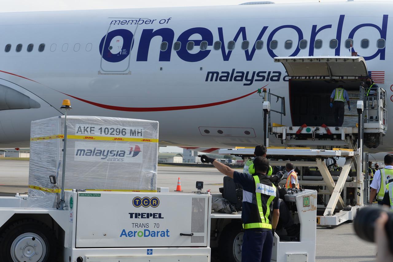 Crates of Covid-19 vaccine by Pfizer-BioNTech are unloaded upon arrival at KLIA in Sepang today. Photo: Bernama