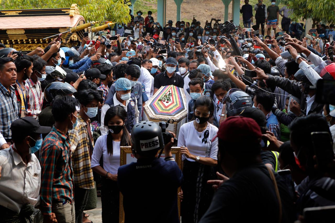 The casket containing the body of Mya Thwet Thwet Khine is carried through the crowds towards the cemetery in Naypyitaw, Myanmar, Feb 21. She was the first confirmed death among the many thousands who have taken to the streets to protest the Feb 1 coup that toppled the elected government of Aung San Suu Kyi. Photo: AP
