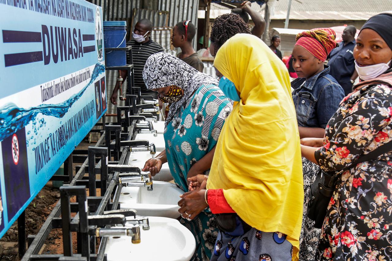 In this May 18, 2020 file photo, people use a hand-washing station installed for members of the public entering a market in Dodoma, Tanzania. Tanzania's President John Magufuli is finally acknowledging that his country has a coronavirus problem after claiming for months that the disease had been defeated by prayer. Photo: AP