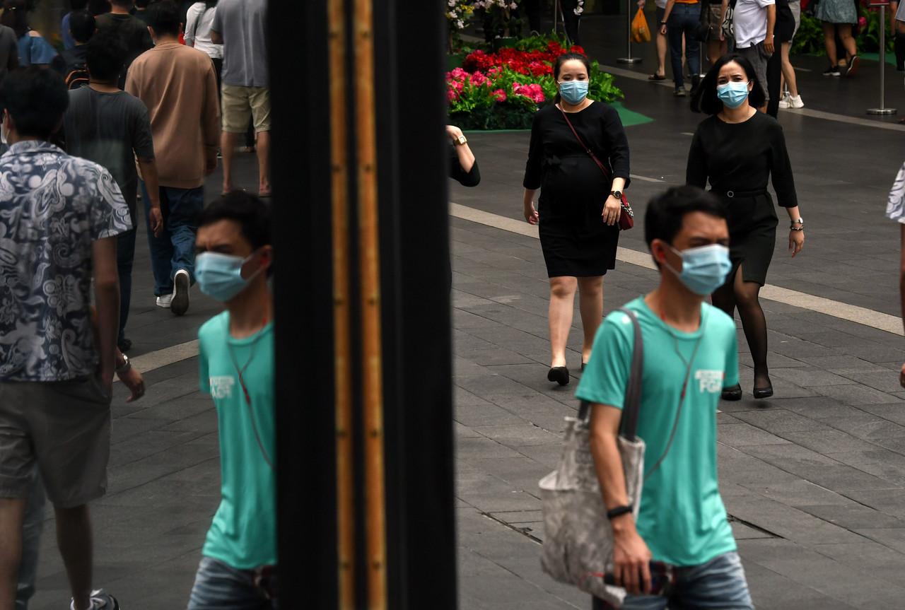 Pedestrians wearing face masks to ward off the spread of Covid-19 go about their daily activities in downtown Kuala Lumpur. Photo: Bernama