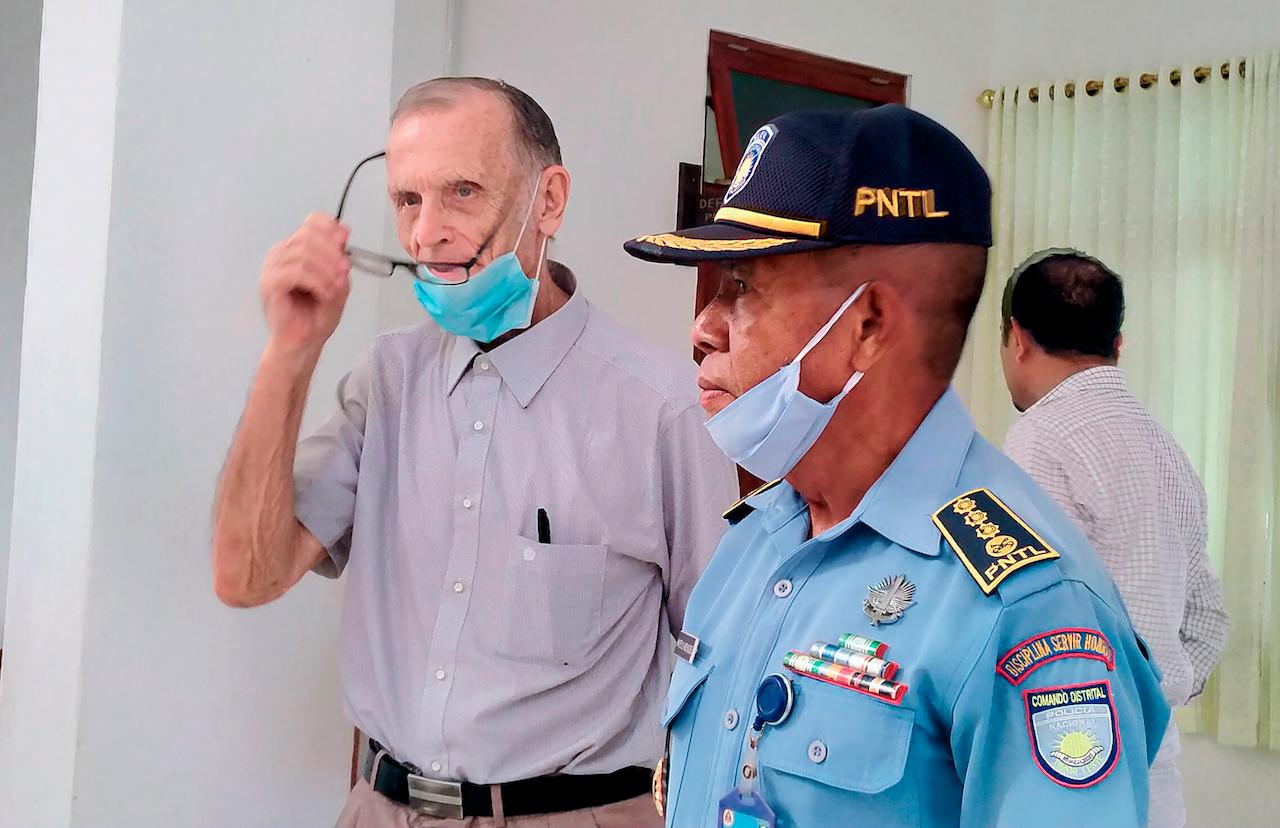 A police officer escorts Richard Daschbach (centre), a former missionary from Pennsylvania, upon his arrival for a trial at a courthouse in Oecusse, East Timor, Feb 22. Photo: AP