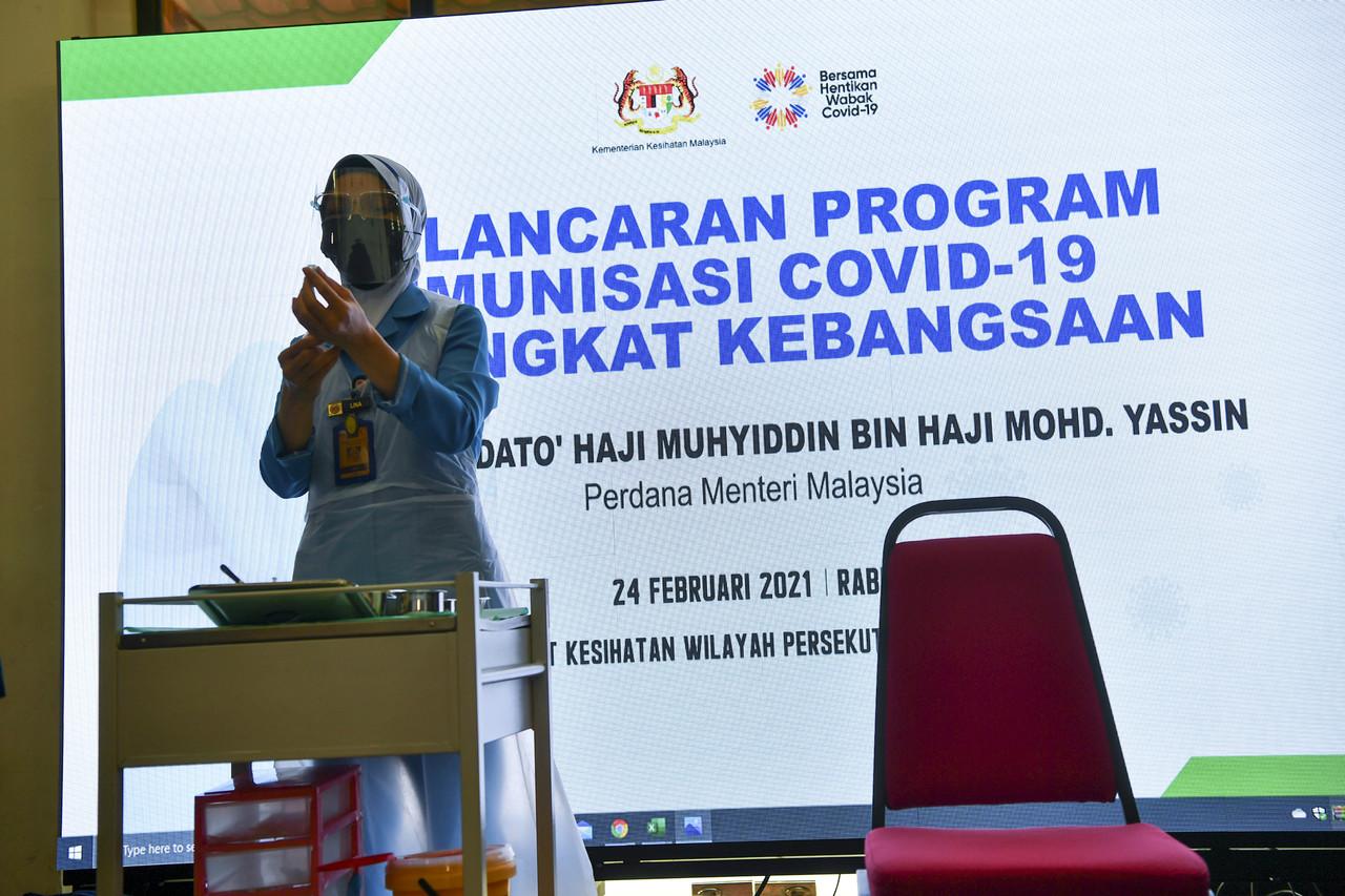 A health worker makes final preparations for the launch of the National Covid-19 Immunisation Programme at the Putrajaya Health Clinic. Photo: Bernama