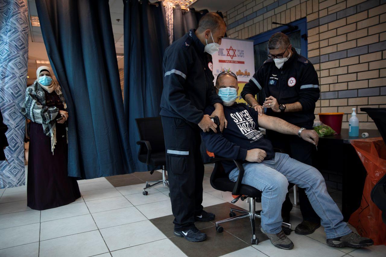 Israeli medical teams administer the Pfizer-BioNTech Covid-19 vaccine to Palestinians at the Qalandia checkpoint between the West Bank city of Ramallah and Jerusalem. Photo: AP