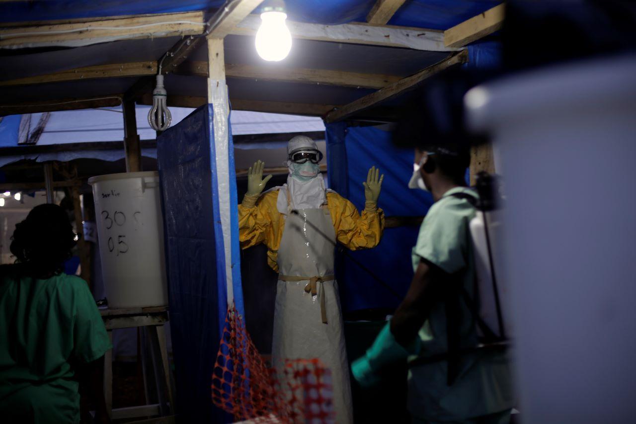 An Ebola heath worker from MSF is sprayed as he leaves the contaminated zone at the Ebola treatment centre in Gueckedou, Guinea. Photo: AP