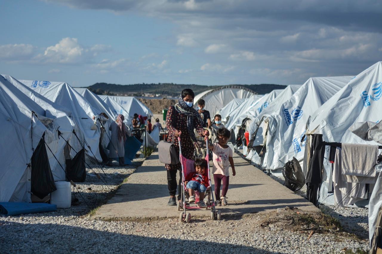 Migrants walk at the Kara Tepe refugee camp on the northeastern Aegean island of Lesbos, Greece, Oct 14, 2020.