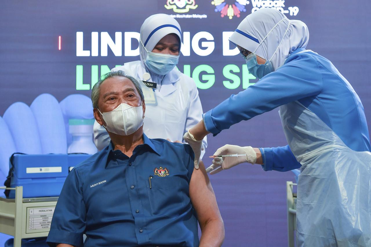 Perdana Menteri Muhyiddin Yassin menerima suntikan vaksin Covid-19 daripada Ketua Jururawat Lina Ibrahim di Pejabat Kesihatan Daerah Putrajaya Presint 11 semalam.