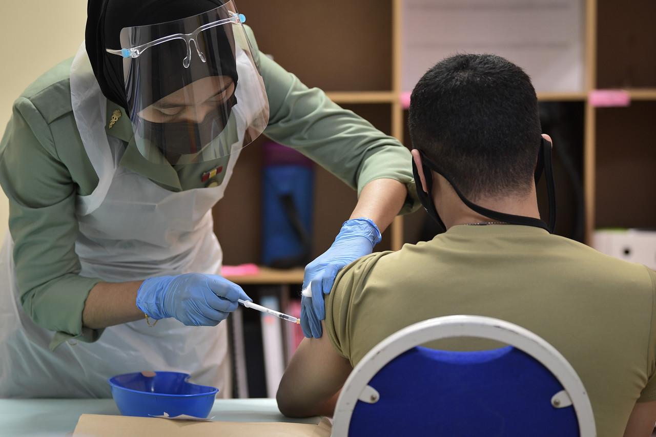 A health worker administers a dose of the Pfizer-BioNTech to a frontliner from the armed forces in Kuala Lumpur. The national Covid-19 vaccination programme began earlier this week with frontliners and medical workers first in line to receive the jabs. Photo: Bernama