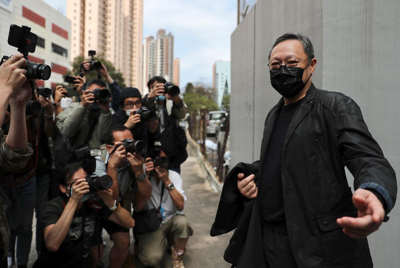 Former law professor Benny Tai (right), a key figure in Hong Kong's 2014 Occupy Central protests who was arrested under Hong Kong's national security law, poses for photographers before entering a police station, Feb 28. Police have detained 47 pro-democracy activists on charges of conspiracy to commit subversion under the sweeping national security law. Photo: AP