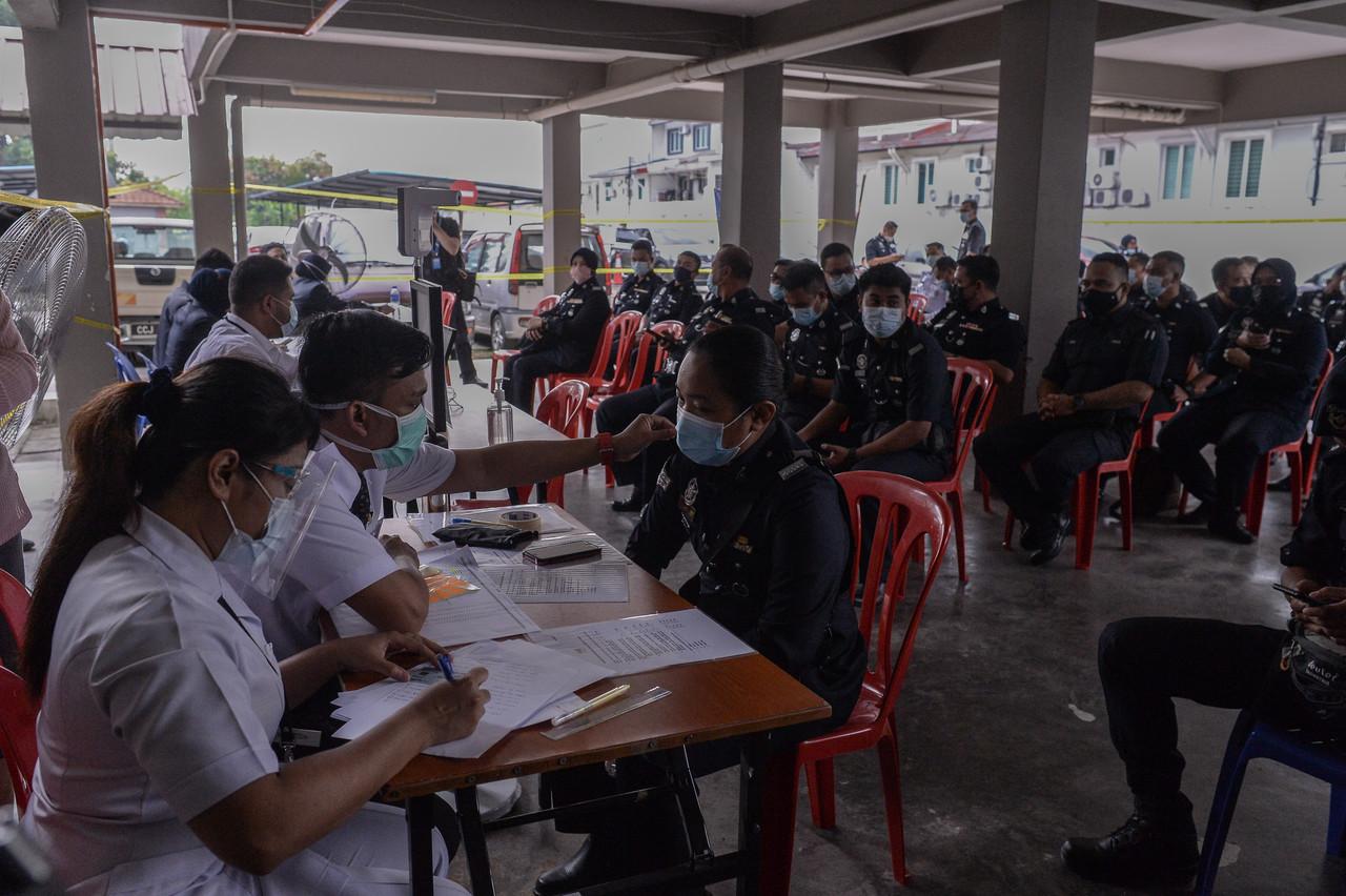 Members of the police force register to receive their jabs under the national vacination programme at the Jinjang health clinic in Kuala Lumpur today. Photo: Bernama