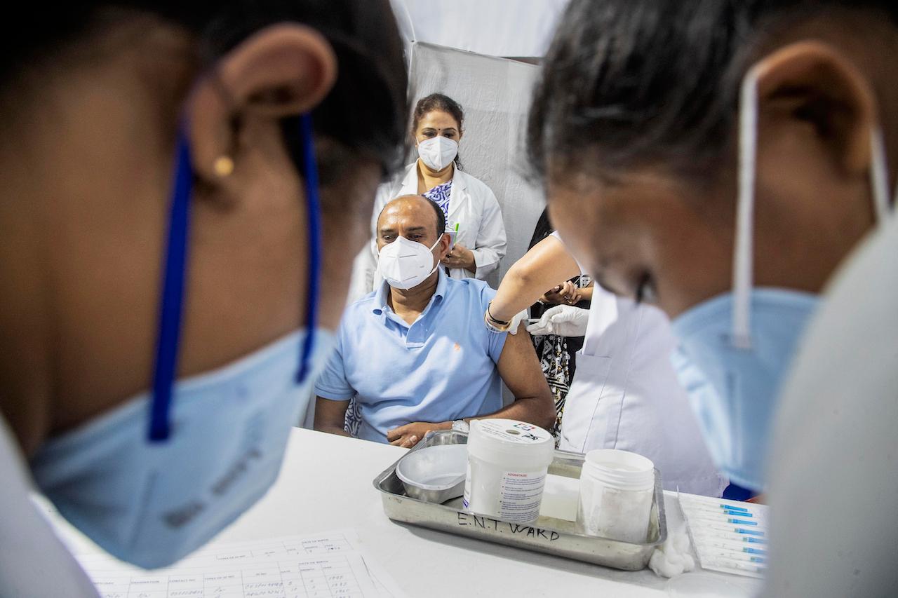 A health worker administers the Covishield vaccine to a man at the Guwahati Medical College hospital in Gauhati, India, March 1. India is expanding its vaccination drive beyond healthcare and frontline workers, offering the shots to older people and those with medical conditions that put them at risk. Photo: AP