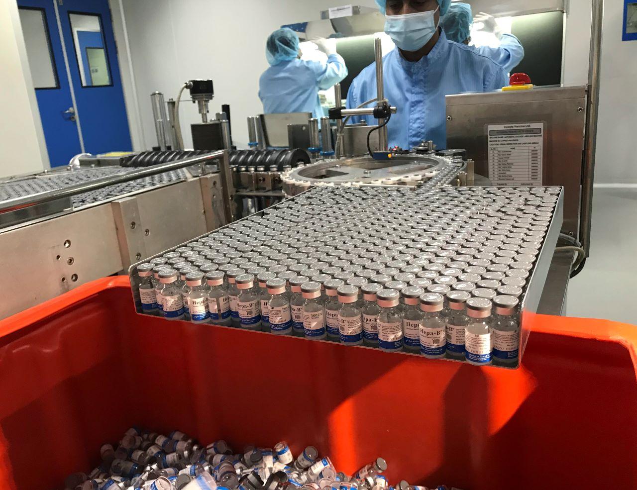 Production personnel label inspected vaccine vials at the Incepta plant on the outskirts of Dhaka in Bangladesh, Feb 13. Nearly 150 sex workers are said to have received their first shot of the AstraZeneca/Oxford vaccine. Photo: AP