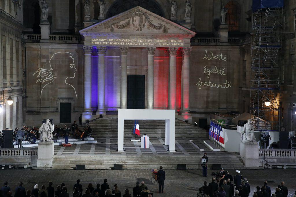 French President Emmanuel Macron pays his respects at the coffin of teacher Samuel Paty, who was beheaded after showing students cartoons of the Prophet Muhammad, in the courtyard of the Sorbonne university during a national memorial event, Oct 21 in Paris. The girl, whose complaints sparked an online campaign against Paty, has now admitted that she was not in the class which sparked the uproar. Photo: AP
