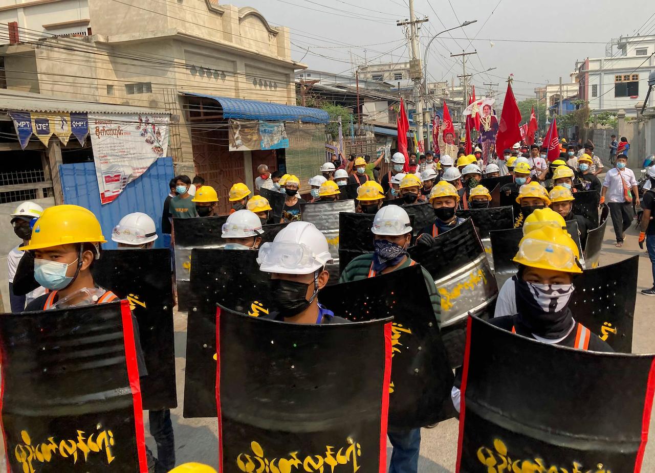 Protesters march with makeshift shields on a main road during a demonstration in Mandalay, Myanmar, March 8. Large protests have occurred daily across many cities and towns in Myanmar. Photo: AP