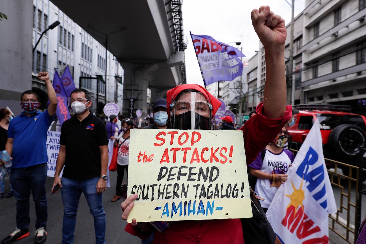 An activist displays a slogan condemning recent government attacks on activists as they hold a rally near the Malacanang presidential palace to mark International Women's Day on March 8 in Manila, Philippines. Philippine police backed by military forces killed nine people over the weekend in a series of raids against suspected communist insurgents, with authorities saying the suspects opened fire first. Photo: AP