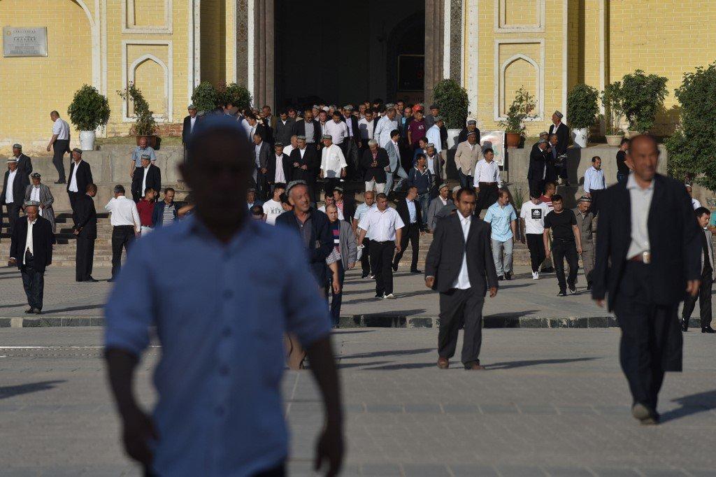 Uighur men leave a mosque in Kashgar, in China's western Xinjiang region. China's treatment of those in the region is one of the issues behind its tense relations with Britain. Photo: AFP