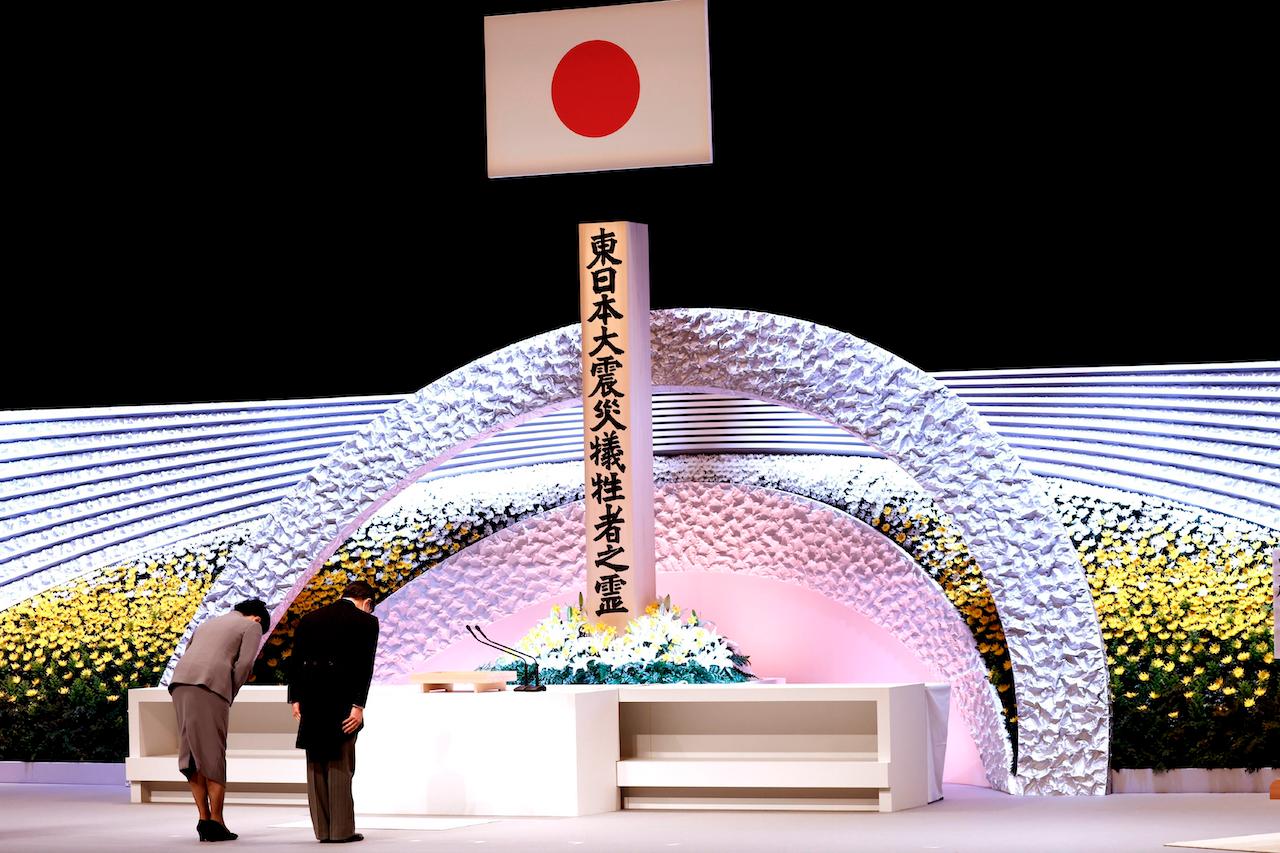 Japan's Emperor Naruhito (right) and Empress Masako bow in front of an altar for victims of the March 11, 2011 earthquake and tsunami at the national memorial service in Tokyo, March 11. Japan is marking the 10th anniversary of the earthquake, tsunami and nuclear disaster with many survivors’ lives are still on hold. Photo: AP