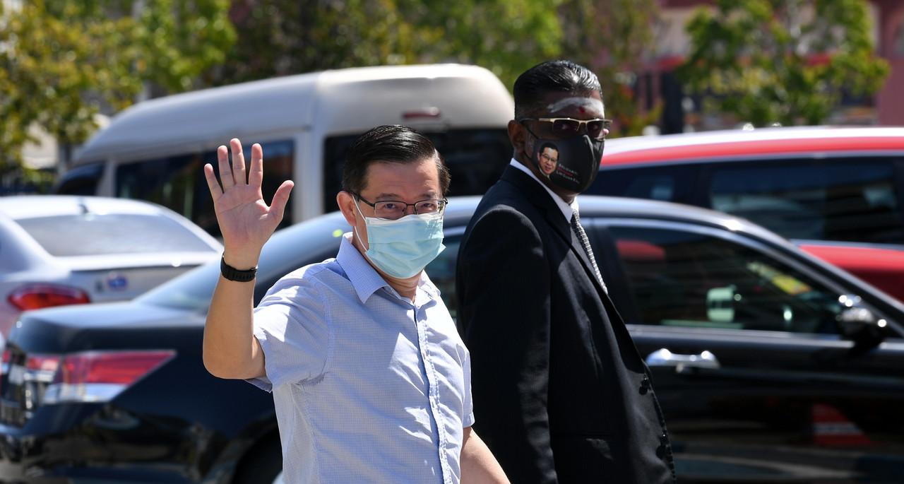 DAP secretary-general Lim Guan Eng at the Timur Laut district police headquarters in George Town with lawyer RSN Rayer today. Photo: Bernama