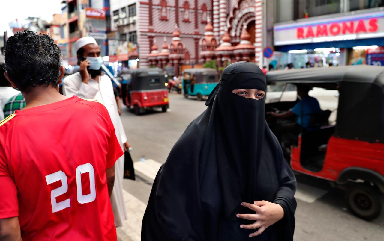 A Sri Lankan Muslim woman wearing a burqa walks in a street of Colombo, Sri Lanka, March 13. Sri Lanka has announced plans to ban the wearing of burqas and says it will close more than 1,000 Islamic schools known as madrassas, citing national security. Photo: AP