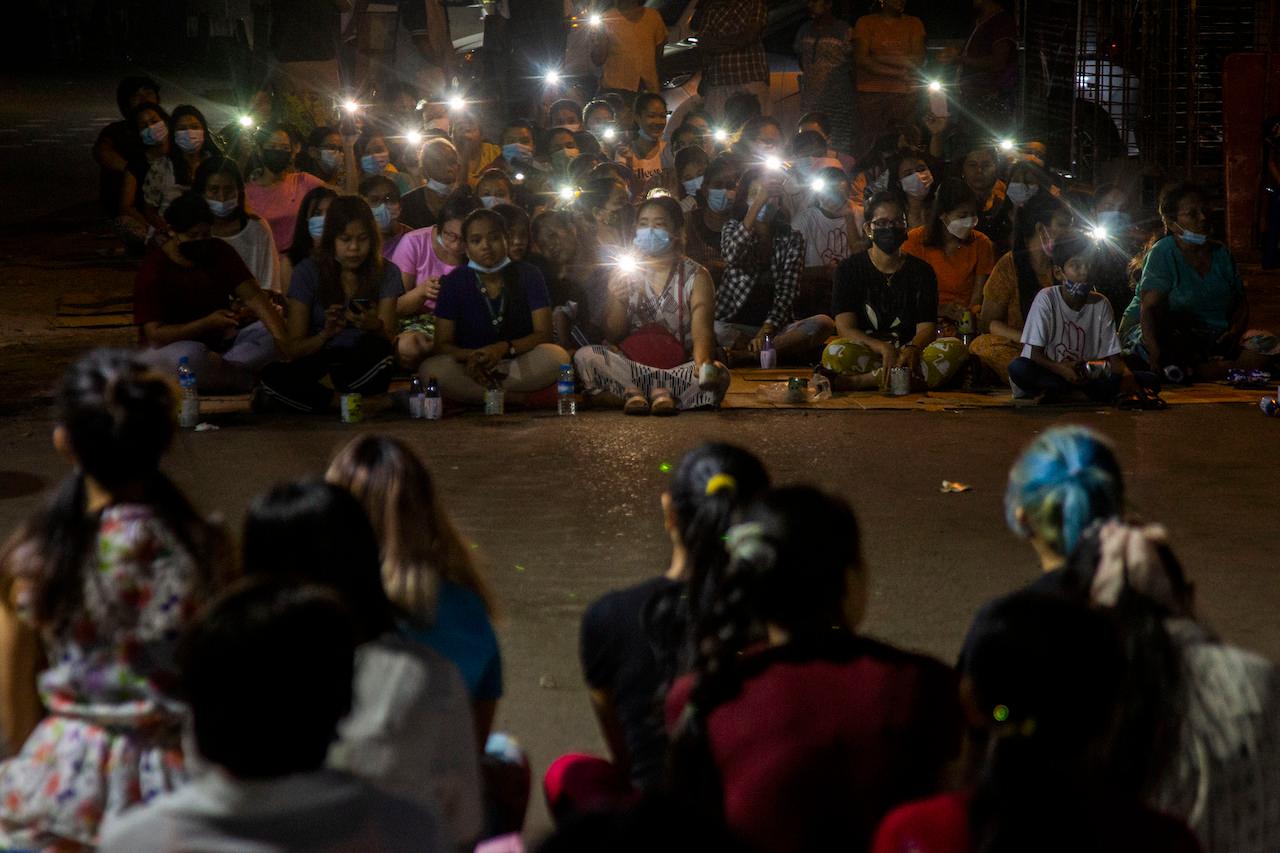 Residents flash the lights from their mobile phones during an anti-coup rally held despite an overnight curfew at the Myaynigone area of Sanchaung township in Yangon, Myanmar, March 15. Myanmar's ruling junta has declared martial law in a wide area of the country's largest city Yangon, as security forces killed dozens of protesters over the weekend in an increasingly lethal crackdown on resistance to last month's military coup. Photo: AP