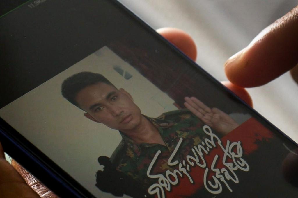 This screengrab taken on March 14 shows Shing Ling, a former Myanmar soldier who deserted the military to join the democracy movement in the aftermath of the military coup, looking at his Facebook profile showing his picture wearing a military uniform and holding up the three finger salute in Yangon. Photo: AFP