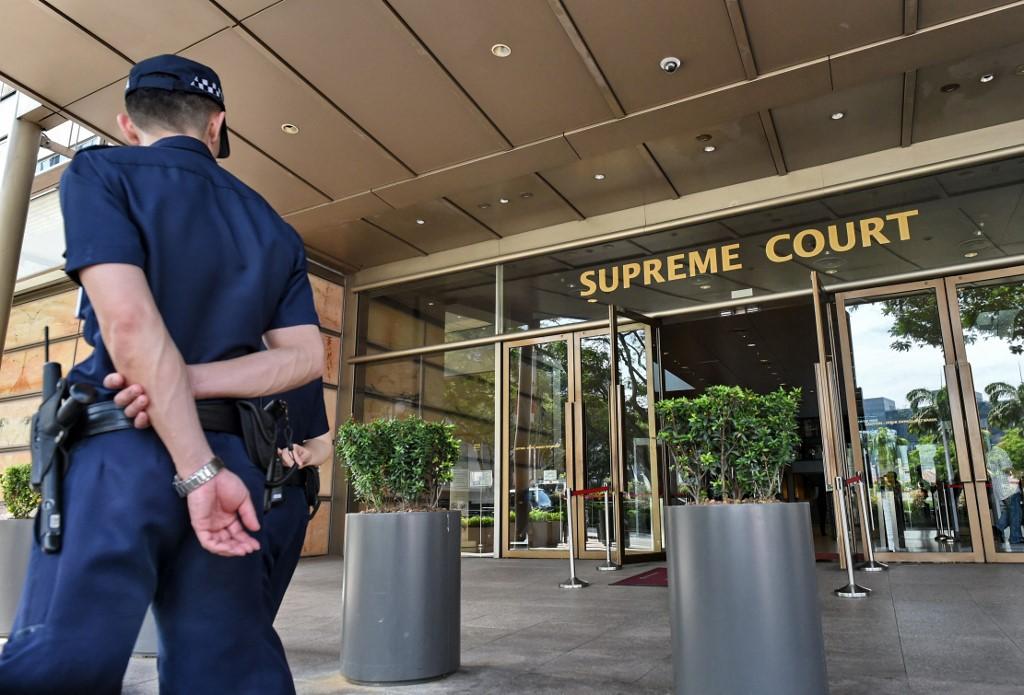 An auxiliary police officer stands outside the Supreme Court in Singapore, which comprises the High Court and Court of Appeal. The High Court has dismissed a suit brought by a group of death row inmates over the unauthorised disclosure of privileged documents between them and their lawyers. Photo: AFP