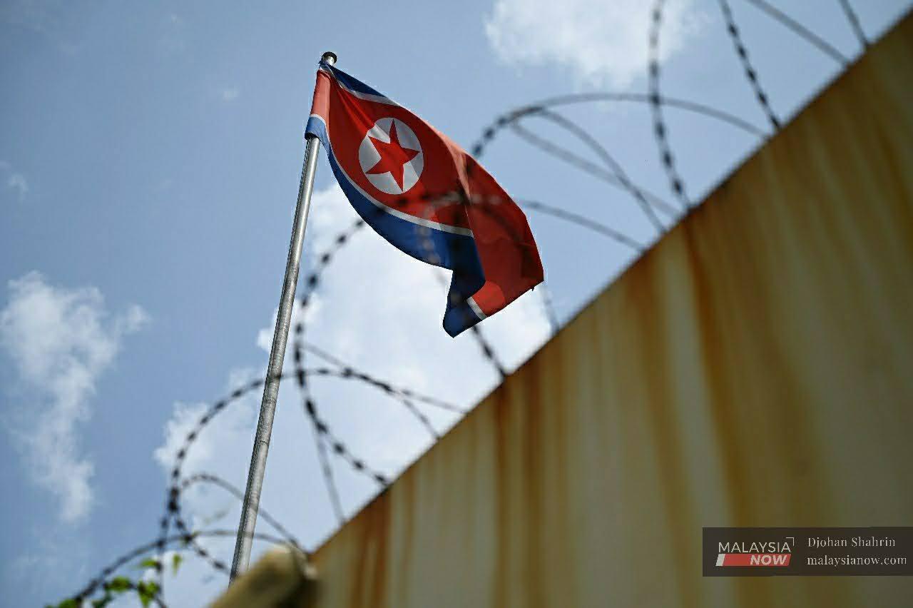 A North Korean flag flies outside the republic's embassy in Kuala Lumpur. Pyongyang announced this morning that it would sever all diplomatic ties with Malaysia over the extradition of one of its citizens to the US to face charges of money laundering.