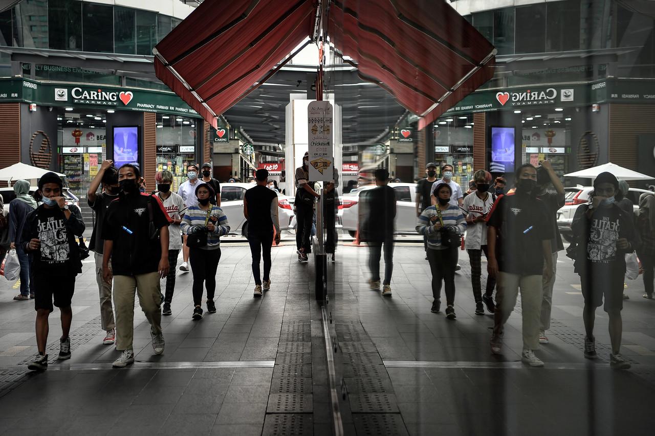 Pedestrians stroll about in Kuala Lumpur which, along with several other states, remains under conditional movement control order to arrest the spread of Covid-19 infections. Photo: Bernama