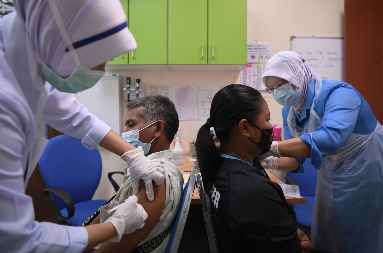 Orang Asli community leaders receive their first dose of Pfizer-BioNTech vaccine at the district health centre in Kuantan, Pahang. They are among 50 Orang Asli in the state who have been given the jabs to encourage others in the community to register for vaccination. Photo: Bernama