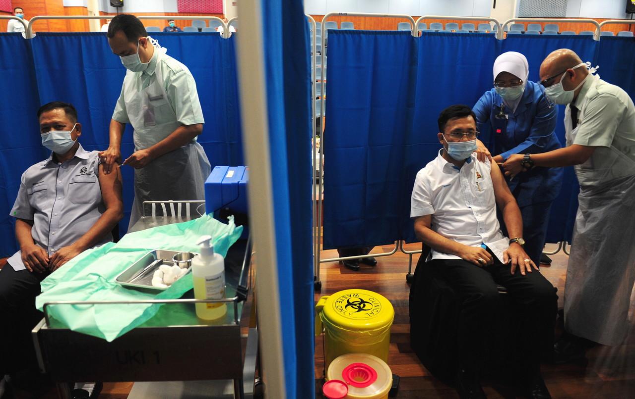 Health workers receive their second dose of the Pfizer-BioNTech vaccine at Hospital Shah Alam in Selangor. Photo: Bernama