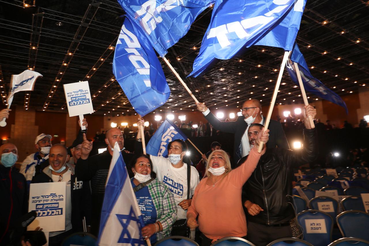 Supporters of Israeli Prime Minister Benjamin Netanyahu celebrate after the first exit poll results for the election at his party's headquarters in Jerusalem, March 23. Photo: AP