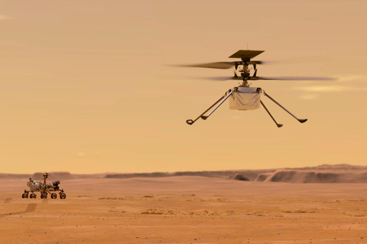 This illustration made available by Nasa depicts the Ingenuity helicopter on Mars which was attached to the bottom of the Perseverance rover (background, left). It will be the first aircraft to attempt controlled flight on another planet. Photo: AP
