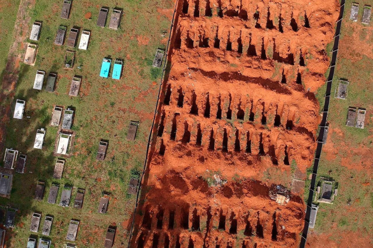 Freshly dug graves are exposed at the Campo da Esperanca cemetery in Brasilia, Brazil, March 23. Brazil has now registered 12.1 million confirmed Covid-19 infections, the second-highest worldwide, after the US. Photo: AP