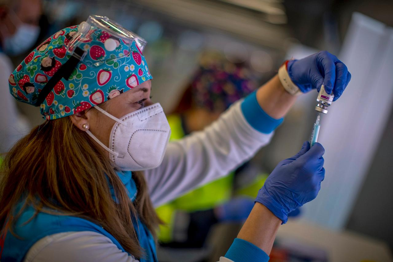 A health worker holds a vial of the AstraZeneca vaccine to be administered to emergency services personnel during a mass Covid-19 vaccination campaign in Madrid, Spain. AstraZeneca was an early frontrunner in the global race to develop a Covid vaccine but a series of communications blunders has eroded confidence in the jabs. Photo: AP