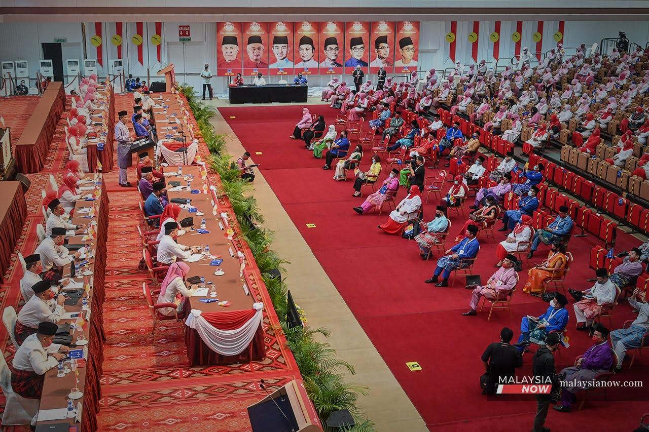 Umno delegates attend the officiating of the party's general assembly by deputy president Mohamad Hasan at the Putra World Trade Centre in Kuala Lumpur today.