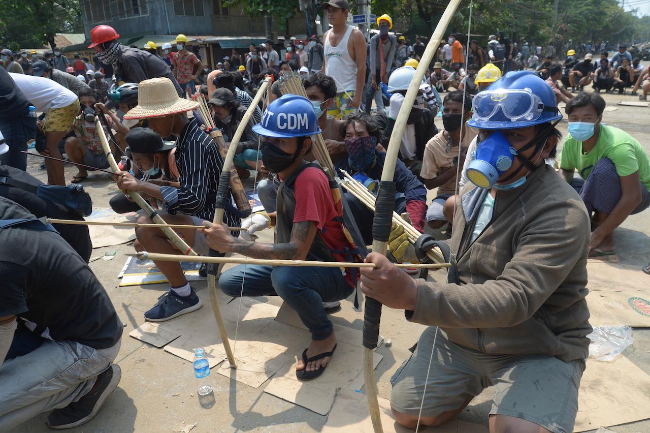 Anti-coup protesters prepare makeshift bow and arrows to confront police in Thaketa township Yangon, Myanmar, March 27. Photo: AP