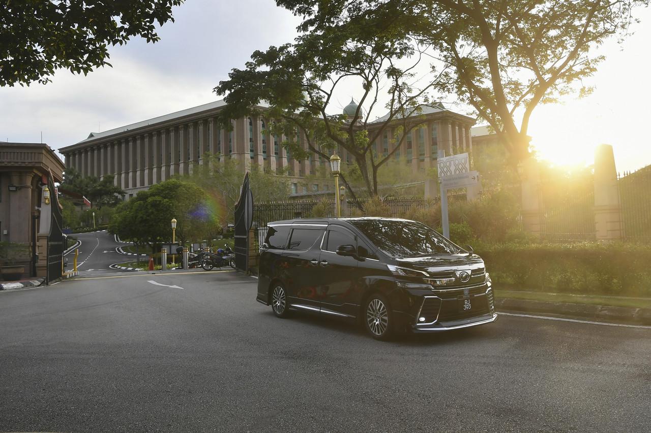 A vehicle carrying a minister leaves Perdana Putra in Putrajaya today. Cabinet ministers from Umno held a brief meeting with Prime Minister Muhyiddin Yassin, a day after he came under attack at the party's general assembly. Photo: Bernama