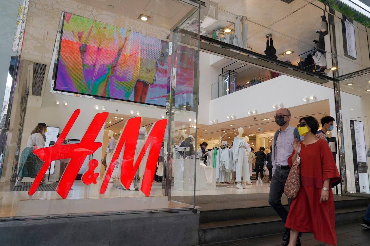 People walk past a H&M clothing store in Hong Kong, March 27. H&M and other popular Western brands are facing a backlash in China after they expressed concern about the alleged use of forced labour in cotton production. Photo: AP