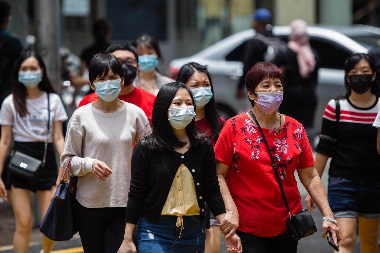 SOPs such as the use of face masks in public areas are a norm under health measures to curb the spread of Covid-19, even as the national vaccination programme progresses. Photo: Bernama