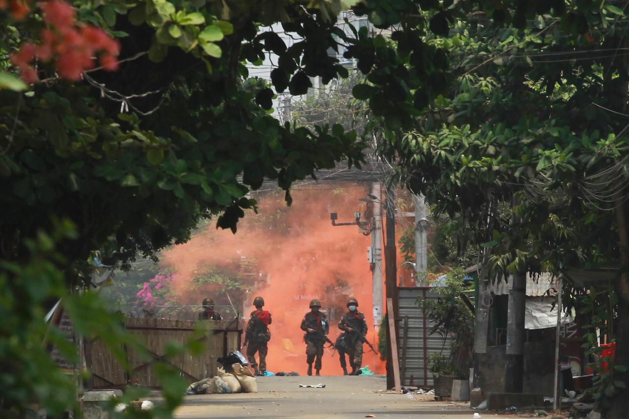Soldiers walk towards anti-coup protesters during a demonstration in Yangon, Myanmar, March 30. Daily rallies across Myanmar by unarmed demonstrators have been met with tear gas, rubber bullets and live rounds. Photo: AP