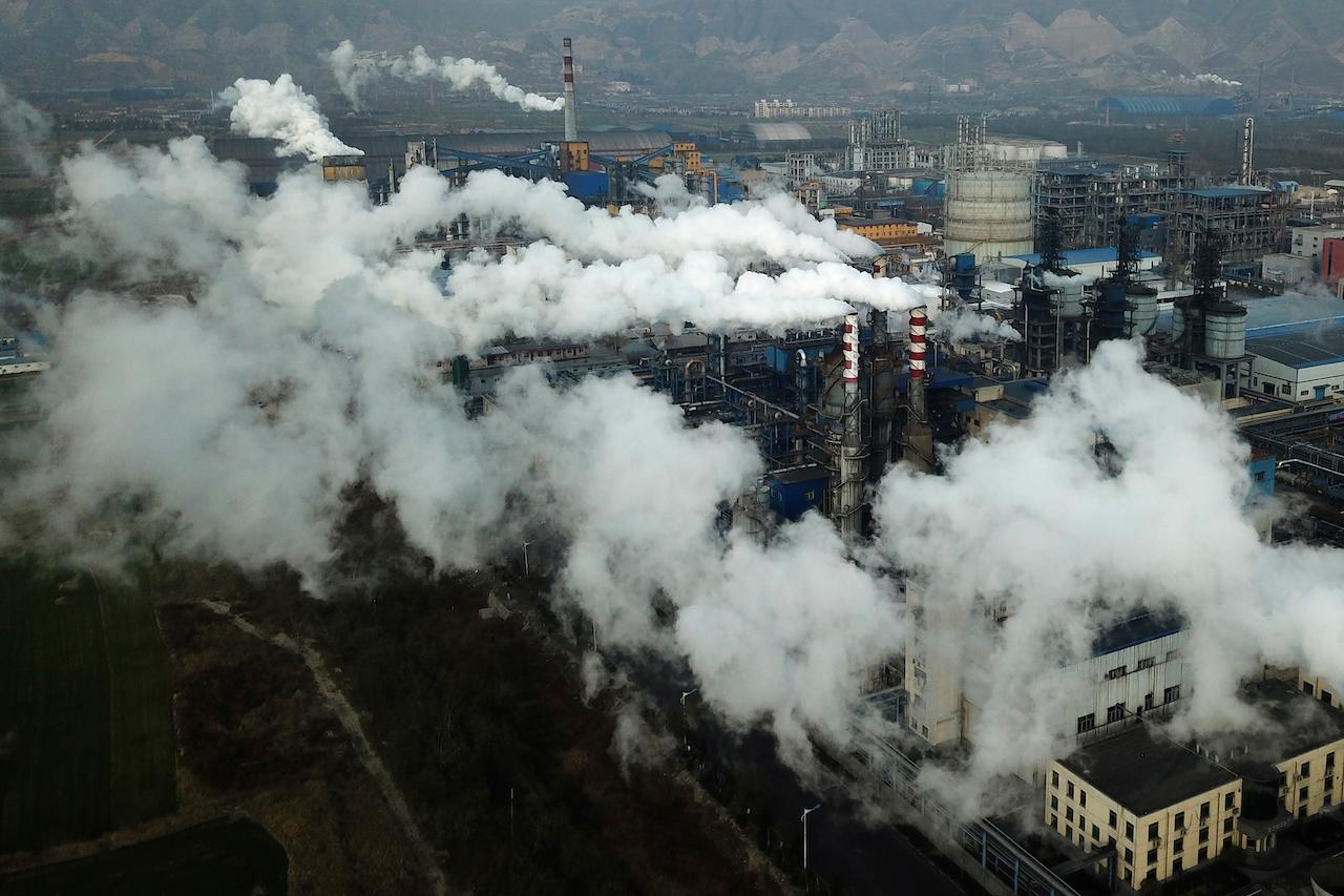 Smoke and steam rise from a coal processing plant in Hejin in central China's Shanxi province, Nov 28, 2019. China is the world's biggest carbon emitter. Photo: AP