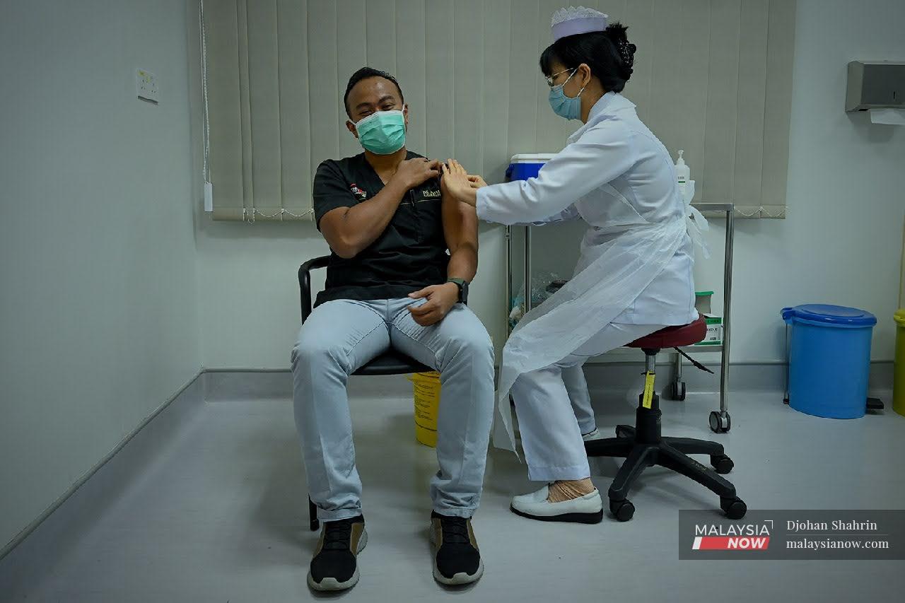 Dr Mohd Naim Mohd Yaakob menerima suntikan vaksin Pfizer BioNTech di Hospital Pengajian Universiti Putra Malaysia (HPUPM) di Serdang.