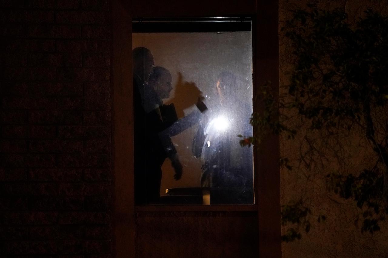 Investigators survey the scene in an office building after a shooting in Orange, California, March 31. The shooter killed several people, including a child, and injured another person before being shot by police. Photo: AP