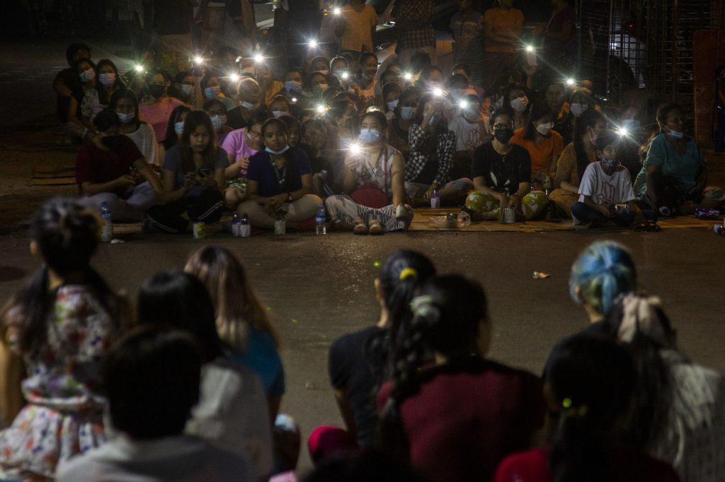 Residents flash the lights from their mobile phones during an anti-coup rally held despite an overnight curfew at the Myaynigone area of Sanchaung township in Yangon, Myanmar, March 15. A local monitoring group puts the overall death toll at 536 and the UN's envoy to Myanmar has warned of the risk of an 'imminent bloodbath' as the crackdown intensifies. Photo: AP