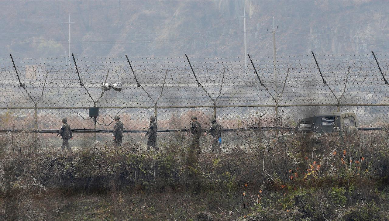 South Korean army soldiers patrol along the barbed-wire fence in Paju, South Korea, near the border with North Korea in this Nov 16, 2018 file photo. North Korea has imposed crippling border closures to combat the pandemic, banned most international travel, and severely restricted movement inside the country. Photo: AP